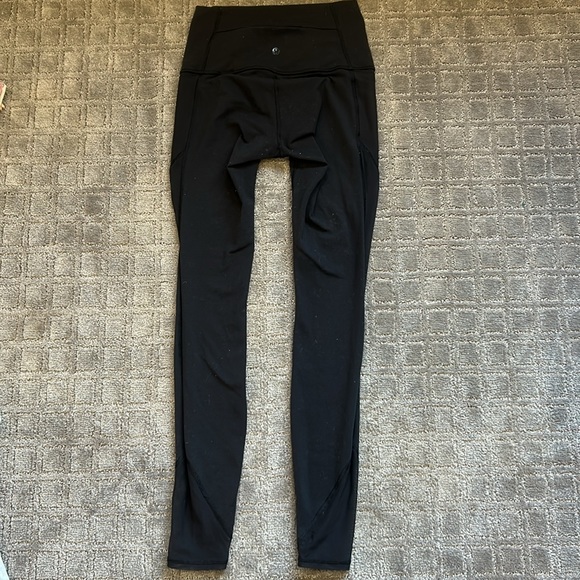 Black Lululemon leggings with lace on the side. Back and side pockets - Picture 2 of 3
